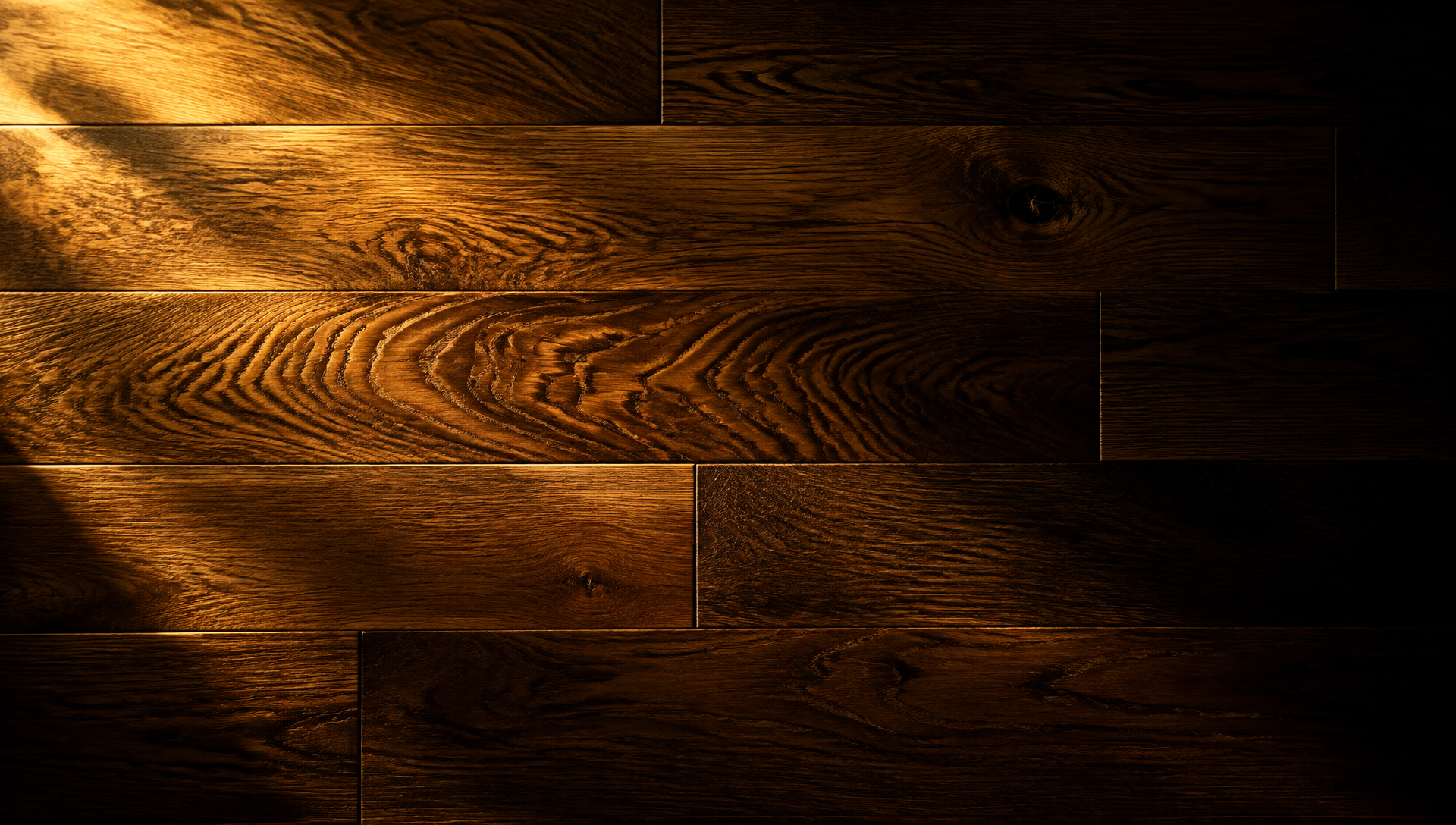 Top view of wide solid oak planks with rich grain under raking light